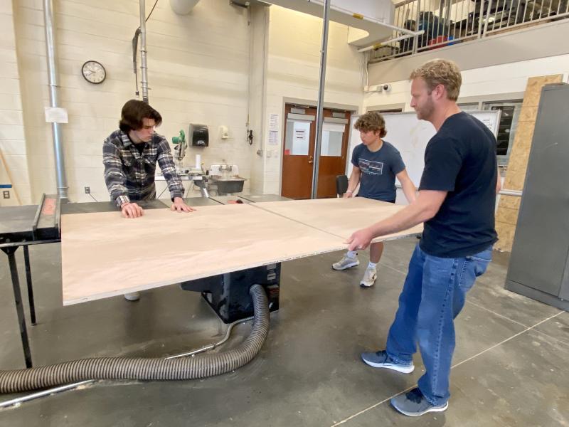 Preparing materials before the event are (l-r) Keller Mancari, Luke McCarthy and Cape High Carpentry, Cabinetry and Design teacher Josh Dickson.